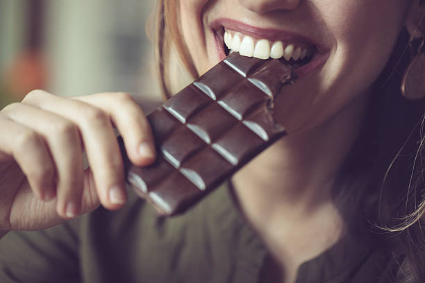 Eating chocolate Eating chocolate dark chocolate stock pictures, royalty-free photos & images