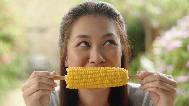 Eating corn on the cob stock photo