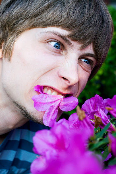 Eating flowers guy stock photo