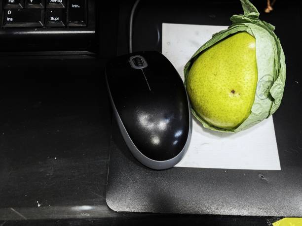 eating fruit at work stock photo