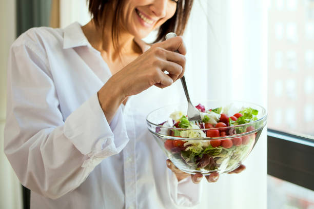 Eating healthy Young woman eating salad salad stock pictures, royalty-free photos & images