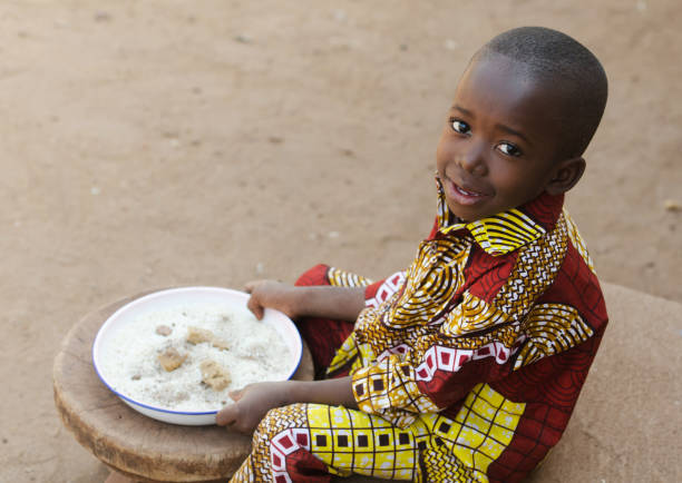 Eating in Africa - Little Black Boy Hunger Symbol stock photo