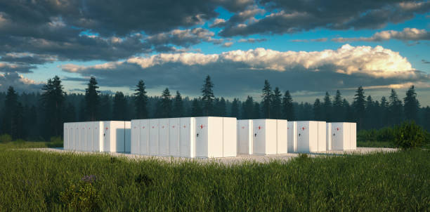 Eco friendly battery energy storage system in nature with misty forest in background and fresh grassland in foreground. 3d rendering.  storage unit stock pictures, royalty-free photos & images