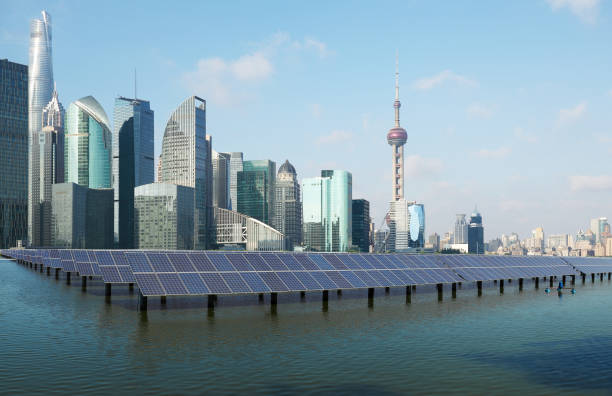 Eco-environmentally friendly green energy of sustainable development of solar power plant with Shanghai skyline stock photo