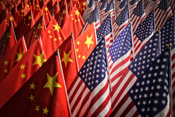 Economic trade war between the USA and China, partnership and diplomacy concept Many American and Chinese national flags together china stock pictures, royalty-free photos & images