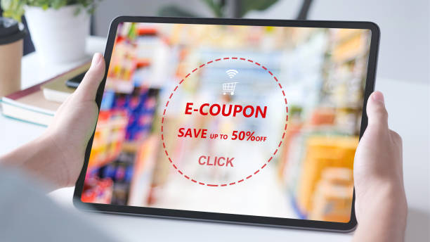 E-coupon, Grocery shopping online, Hand using digital tablet with discount coupon on screen, online shopping sale, digital marketing, retail business and technology, e commerce promotion concept stock photo