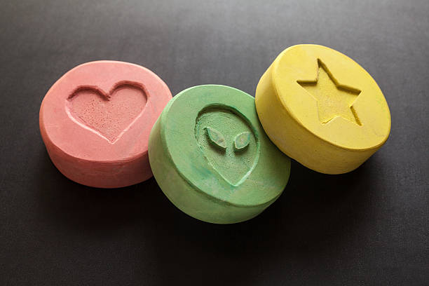Ecstasy pills Ecstasy tablets on black background mephedrone stock pictures, royalty-free photos & images