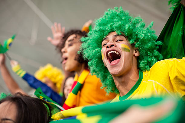 Ecstatic Brazilian fan watching a Football game stock photo