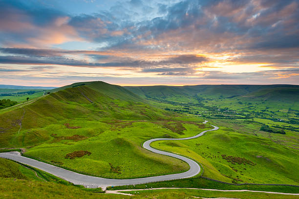 Edale Valley Road, Peak District National Park Looking down on a winding country road that descends into Edale Valley in the Peak District National Park. XL image size. peak district national park stock pictures, royalty-free photos & images