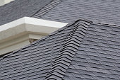 istock edge of Roof shingles on top of the house, dark asphalt tiles on the roof background. 1015295082