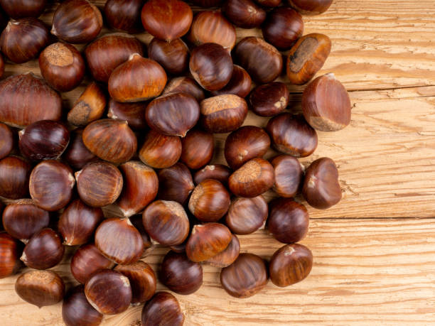 Edible Chestnuts on wooden background stock photo