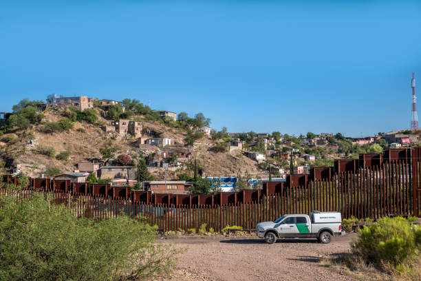 Editorial June 9, 2017 - US Mexico International Border Border fence dividing the United States and Mexico in Nogales, Arizona border patrol stock pictures, royalty-free photos & images