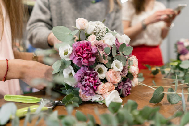 education in the school of floristry. Master class on making bouquets. Summer bouquet. Learning flower arranging, making beautiful bouquets with your own hands. Flowers delivery stock photo