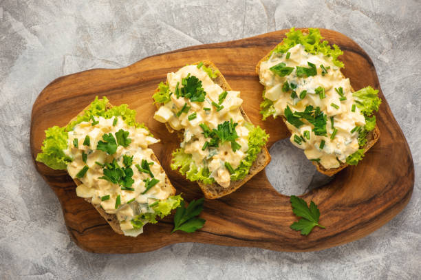 Egg salad sandwiches, on light background. stock photo