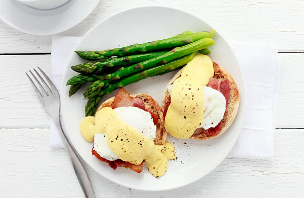 Eggs Benedict Eggs Benedict with a side of asparagus. poached food photos stock pictures, royalty-free photos & images