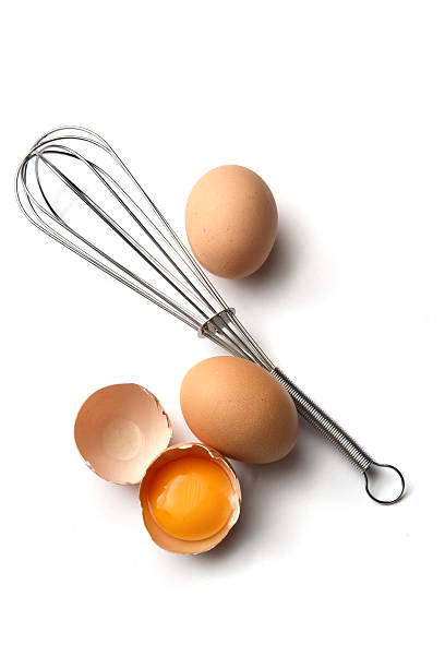 eggs: whisk and eggs - keukengereedschap stockfoto's en -beelden