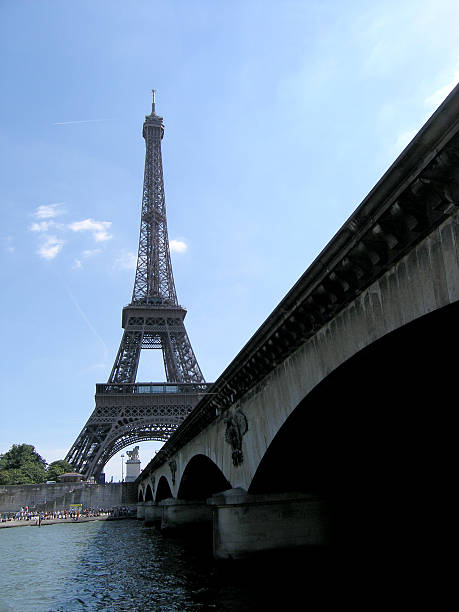 Eiffel Tower from riverbank Eiffel Tower with bridge in foreground. skeable stock pictures, royalty-free photos & images