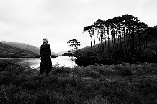 Woman at Loch Eilt, west of Glenfinnan, Scottish Highlands, UK, famous as a film location.