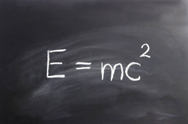 Einstein formula written on a blackborad Einstein formula  E= mc2 written on a black chalkboard e=mc2 stock pictures, royalty-free photos & images