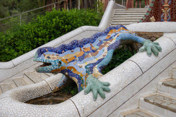 "El Drac" dragon or lizard sculpture on the staircase of Parc Guell by Antoni Gaudi in Barcelona stock photo