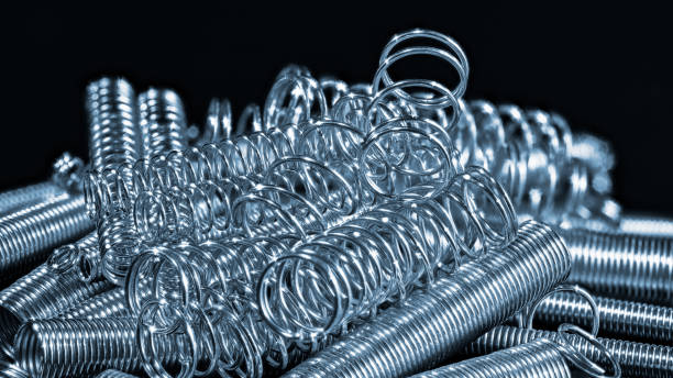 Elastic stainless steel compression and extension coil springs. Helical wire winding detail stock photo