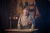 elderly alchemist monk  with candle