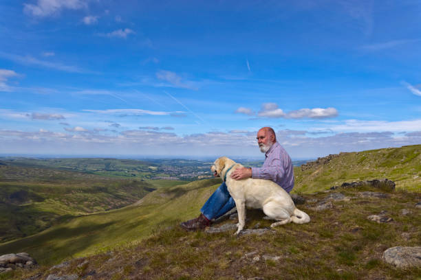 Elderly man and his dog in the Peak District stock photo
