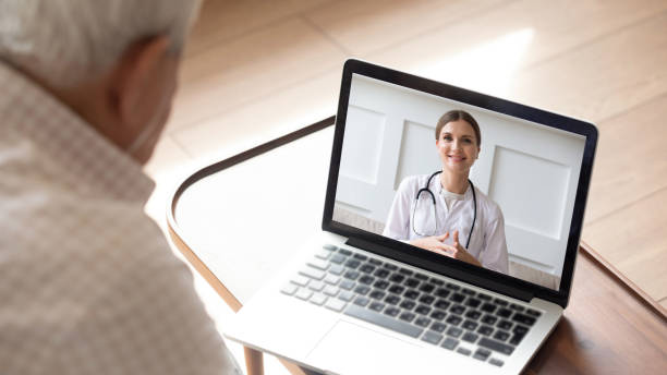 Elderly man having online video consultation with doctor Close up of modern elderly man sit at home having online consultation with doctor on computer, sick senior male talk on video call consulting with female nurse using laptop, healthcare concept nurse talking to camera stock pictures, royalty-free photos & images