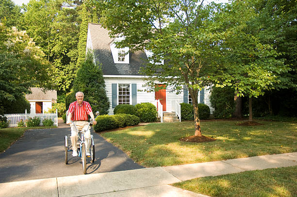 Elderly Man Taking A Ride On Bike  adult tricycle stock pictures, royalty-free photos & images