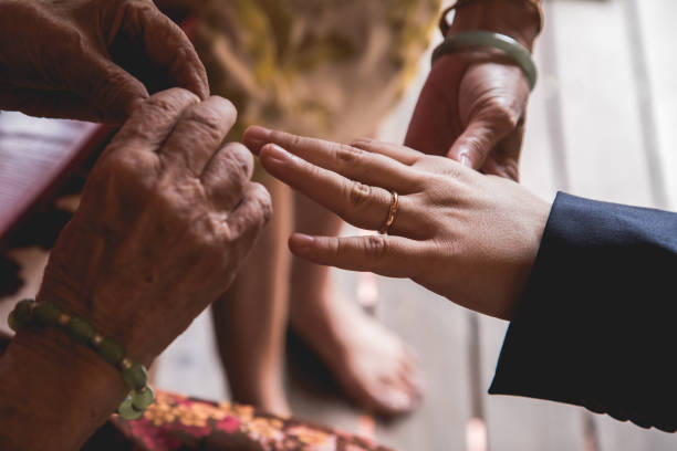 Elderly putting on a gift ring on the newlywed stock photo