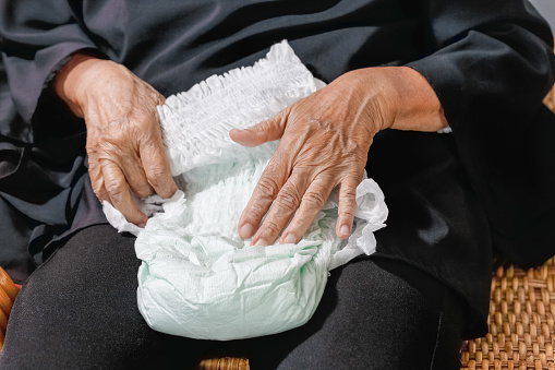 elderly woman changing diaper
