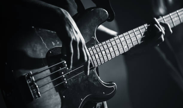 Electric bass guitar black and white photo Electric bass guitar player hands, live music theme, black and white photo rock musician stock pictures, royalty-free photos & images