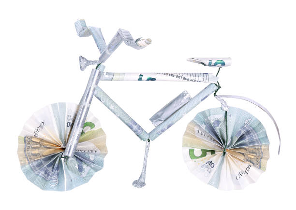 Electric bicycle made from banknotes, isolated stock photo