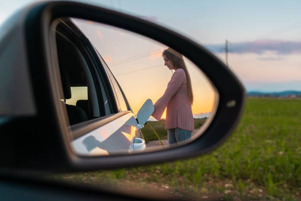 electric car charge in a rear mirror - electric car woman bildbanksfoton och bilder
