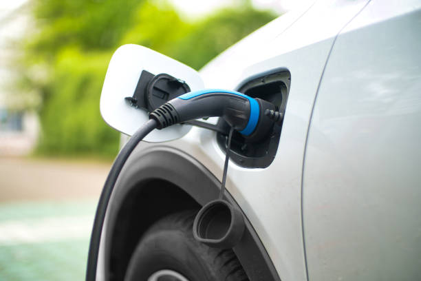 electric car charging at power station - electric car imagens e fotografias de stock