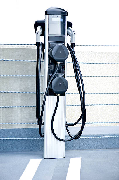 Electric Car Charging Station Electric car charging station in a public parking lot.Other images from the series. battery charger stock pictures, royalty-free photos & images