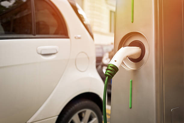 Electric car in charging An electric car in charging on the street electric vehicle charging station photos stock pictures, royalty-free photos & images