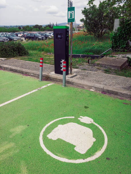 EV electric car power station with blink logo at outdoors parking area. stock photo