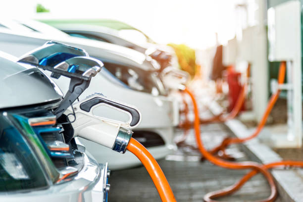 Electric cars are charging in station stock photo