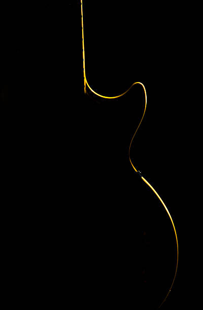 Electric guitar gold silhouette on a black background stock photo