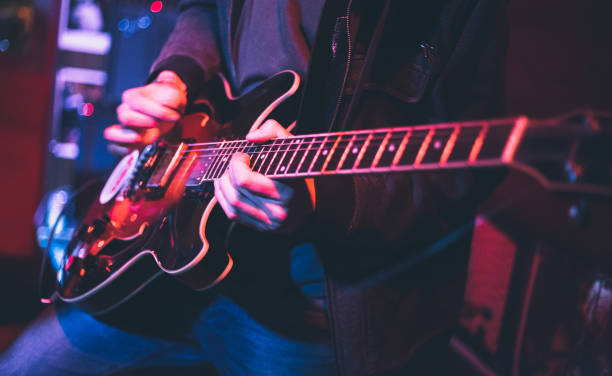Electric guitar player on a stage stock photo