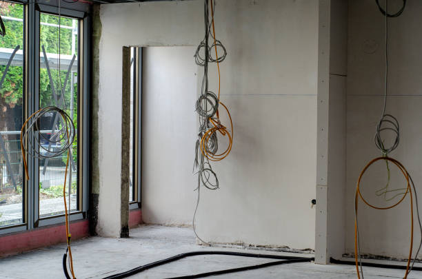 Electric installation work. Pulling wires in an unfinished house stock photo