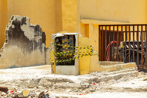 Havana, Cuba - May 18, 2022: Electricity devices are surrounded by a caution tape in a building that has collapsed. There are no people. The scene of collapsed buildings is common in the Communist-run island.