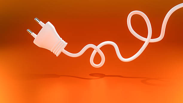 Electric plug on orange background stock photo