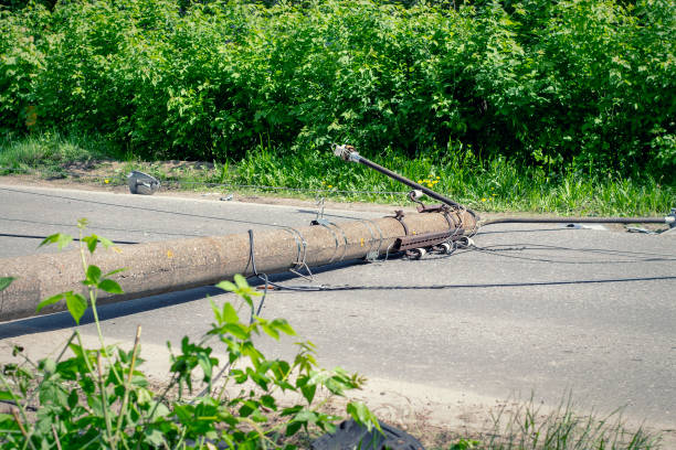 Electric pole. Broken broken wood power line post with electrical components on the ground after accident. stock photo