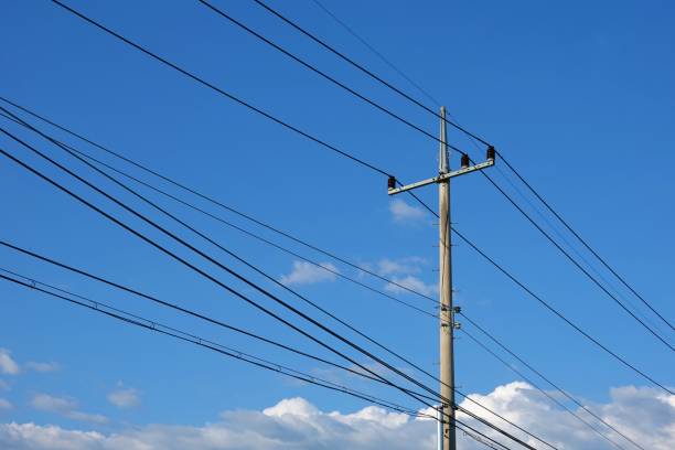 Electric pole Electric Pole with blue autumn sky and clouds. power cable stock pictures, royalty-free photos & images