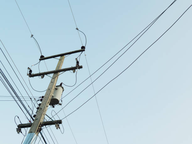 Electric poles and transformers Electricity industry sends electricity to houses. stock photo