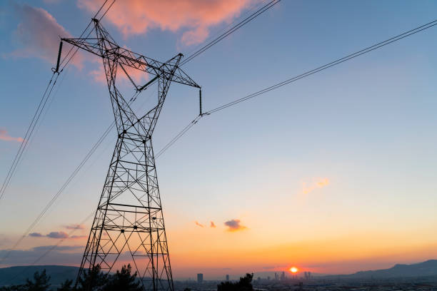 Electric power lines at sunset Electric power lines at sunset high voltage sign photos stock pictures, royalty-free photos & images