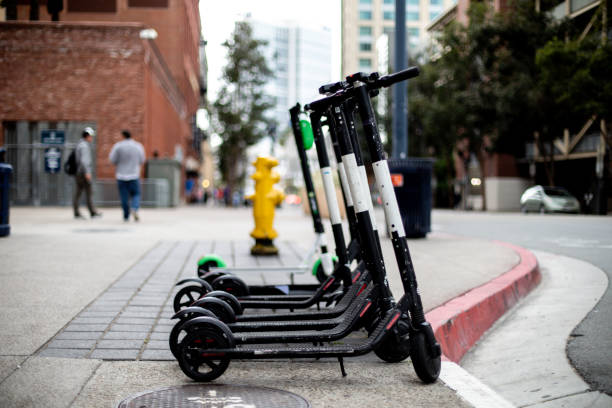 Electric Scooters For Rent Electric scooters in a city available for rent motor scooter stock pictures, royalty-free photos & images