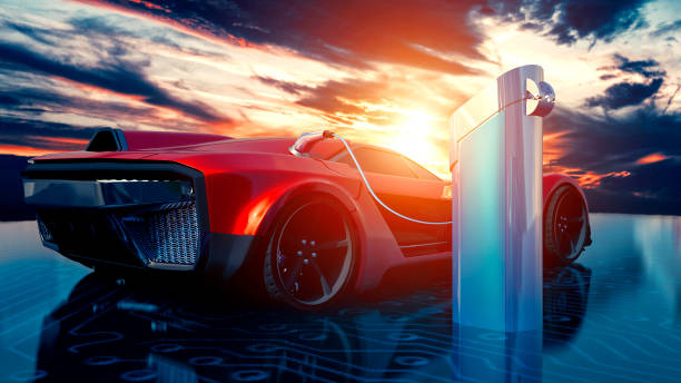 Electric sports car gets charged with solar power outside as the sun sets Red sports car is parked next to a charging station where the electric car can its batteries charged. The sun is setting in the horizon. The ground looks like a circuit board. electric vehicle photos stock pictures, royalty-free photos & images